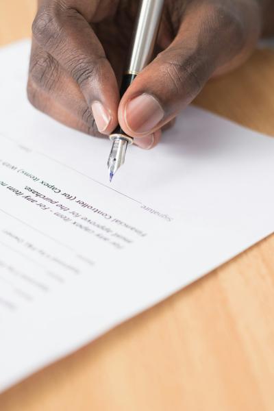 person about to sign paper